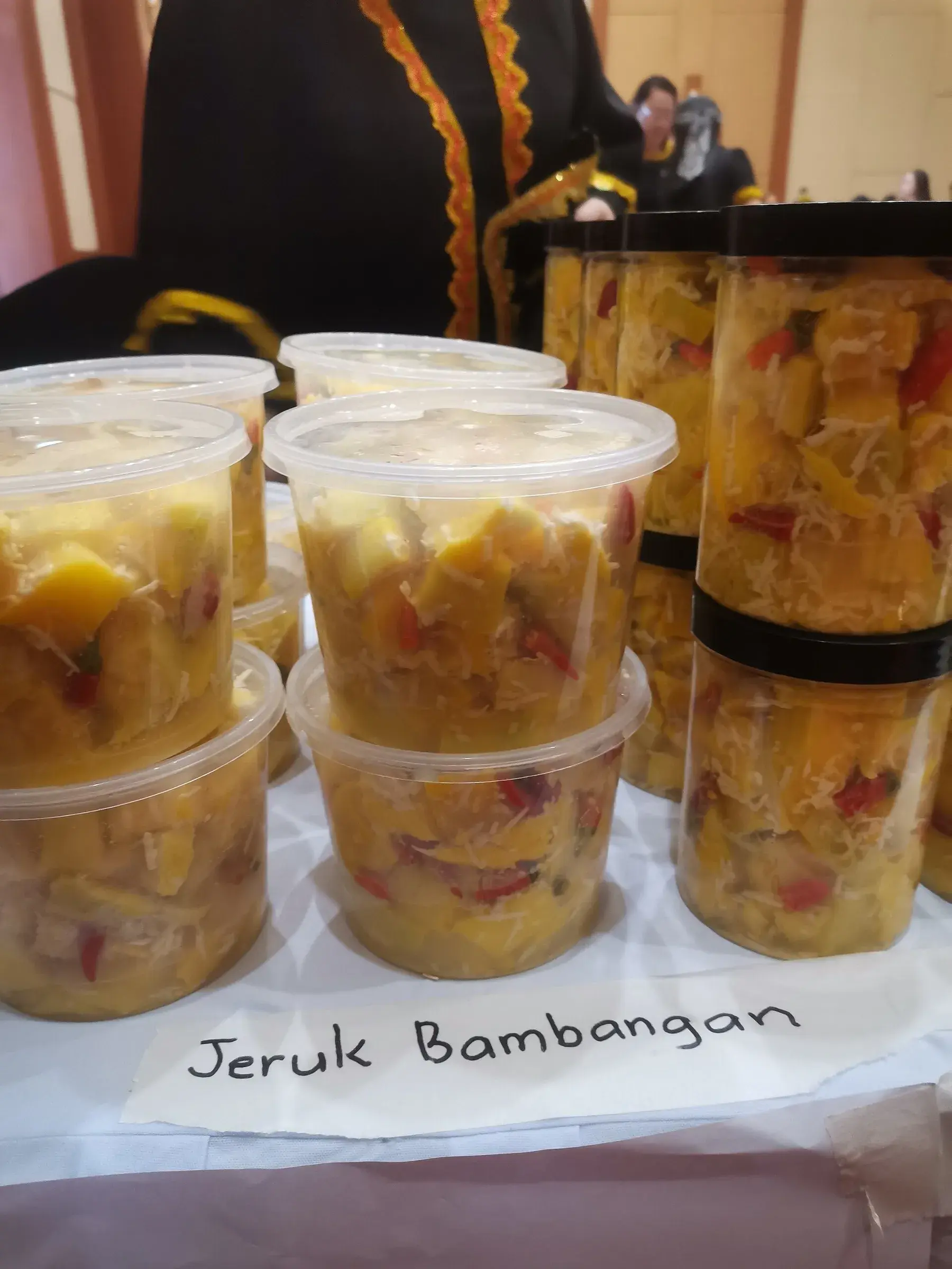 Tubs of jeruk bambangan, pickled wild mango, for sale
