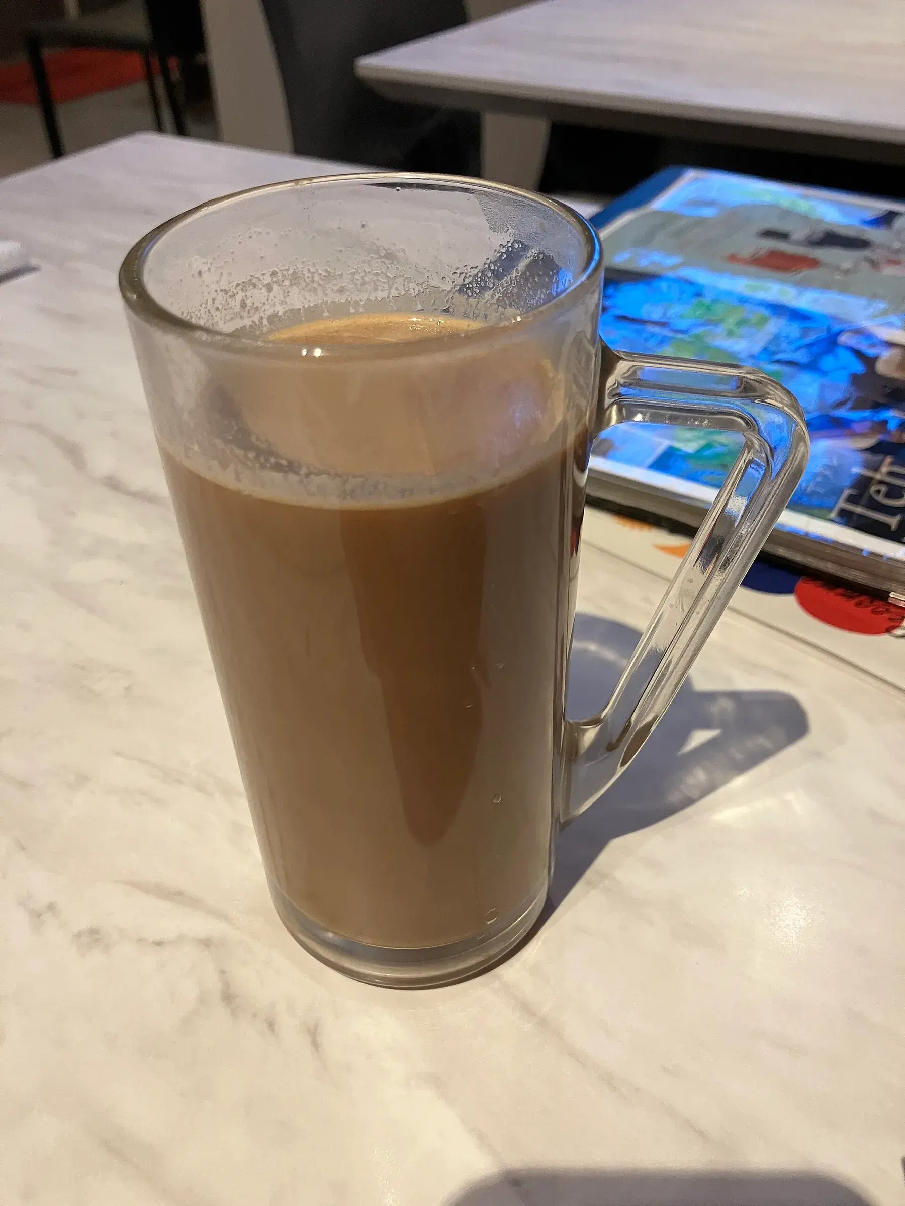A glass of milky kopi